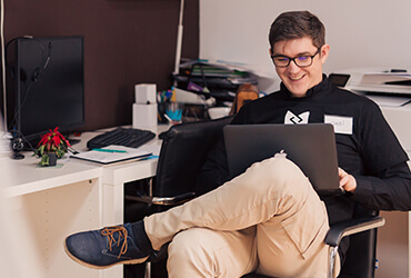 A man sitting in front of a laptop computer.