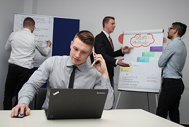 A man sitting at a table with a laptop.